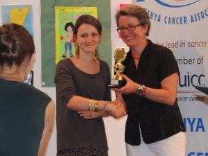 The art teacher from one of the schools receives an award on her student's behalf.